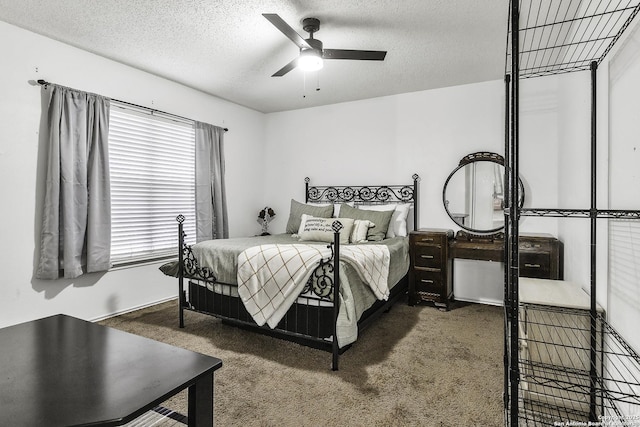 bedroom featuring ceiling fan, a textured ceiling, and dark colored carpet