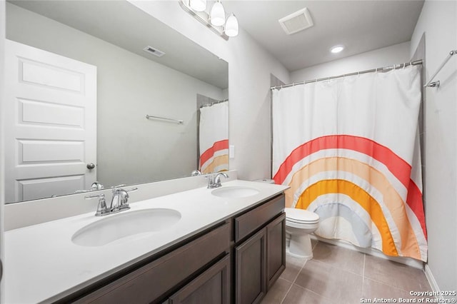 bathroom with vanity, tile patterned floors, and toilet