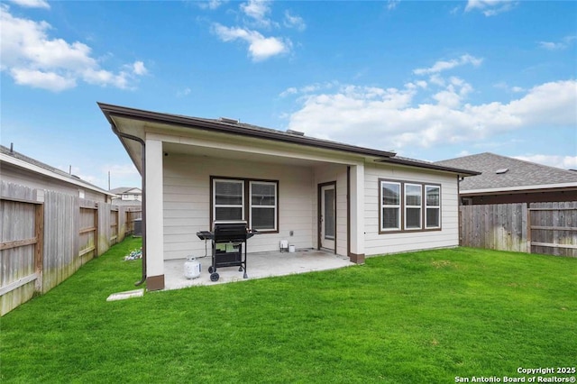 back of house featuring a patio and a lawn