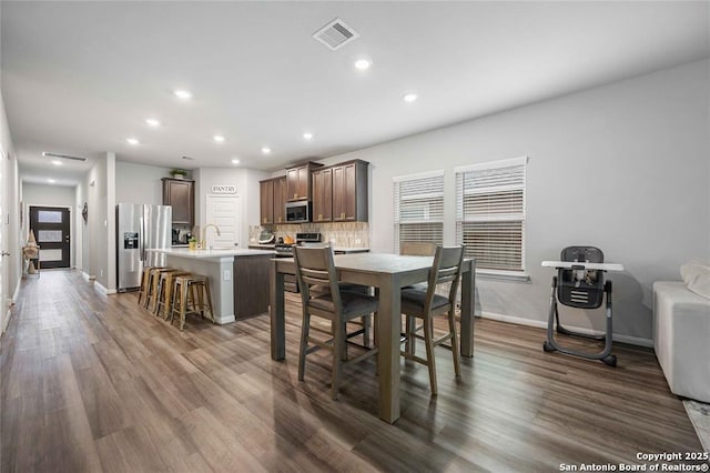 dining room featuring dark hardwood / wood-style floors and sink