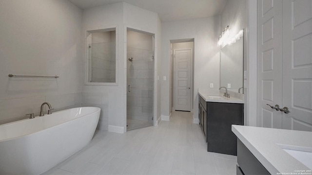 109 Barton Crk, Boerne, TX 78006 - full bathroom featuring a shower stall, two vanities, a soaking tub, tile patterned floors, and baseboards