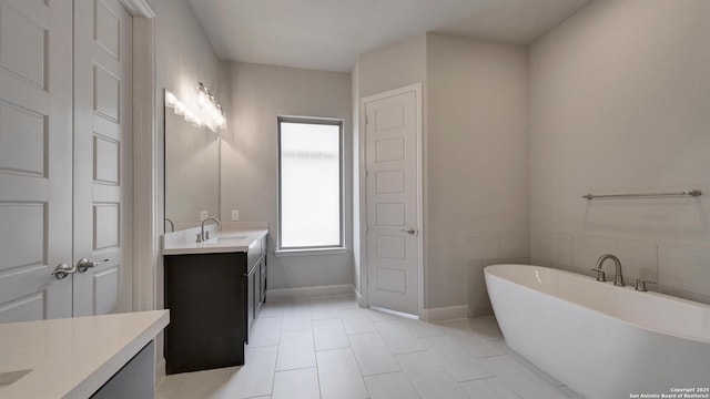 109 Barton Crk, Boerne, TX 78006 - full bath featuring vanity, a soaking tub, tile patterned flooring, and baseboards