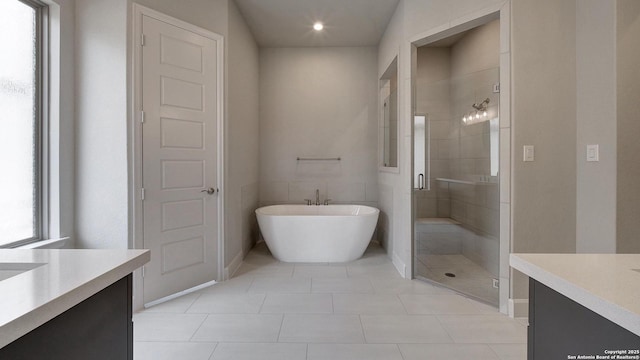 109 Barton Crk, Boerne, TX 78006 - bathroom featuring vanity, a stall shower, a soaking tub, tile patterned floors, and baseboards