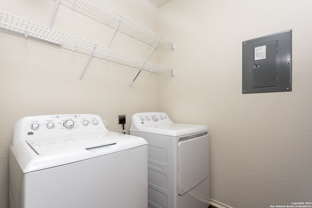 clothes washing area featuring electric panel and washing machine and clothes dryer