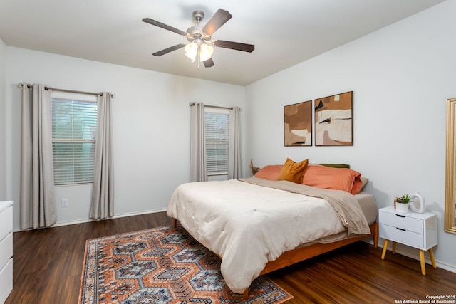 bedroom with dark hardwood / wood-style floors and ceiling fan