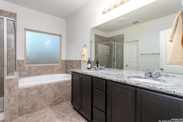 bathroom featuring vanity, shower with separate bathtub, and tile patterned flooring