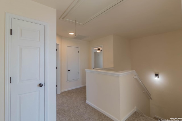 corridor with light colored carpet