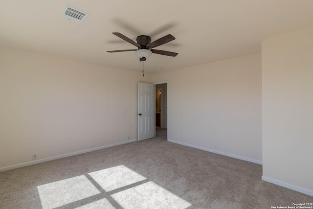 empty room featuring light colored carpet and ceiling fan