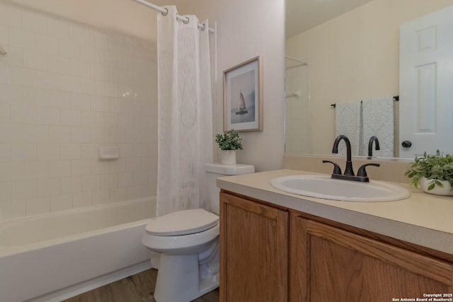 full bathroom with hardwood / wood-style flooring, vanity, shower / tub combo, and toilet