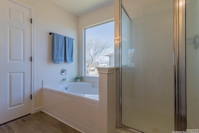 bathroom with wood-type flooring and separate shower and tub