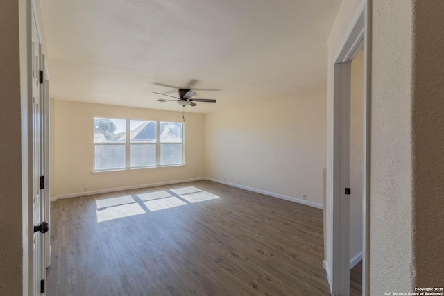 unfurnished room featuring ceiling fan and hardwood / wood-style floors