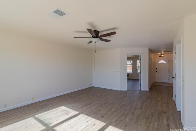 spare room with ceiling fan and hardwood / wood-style floors