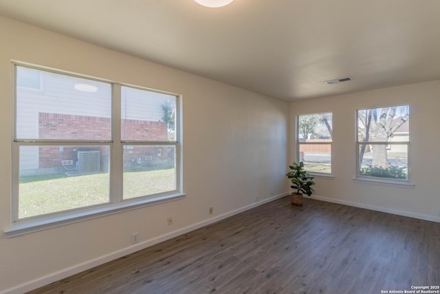 empty room with dark wood-type flooring