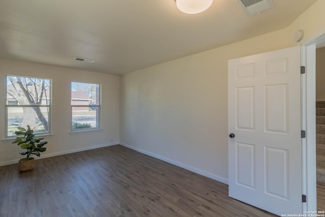 unfurnished room with dark hardwood / wood-style floors