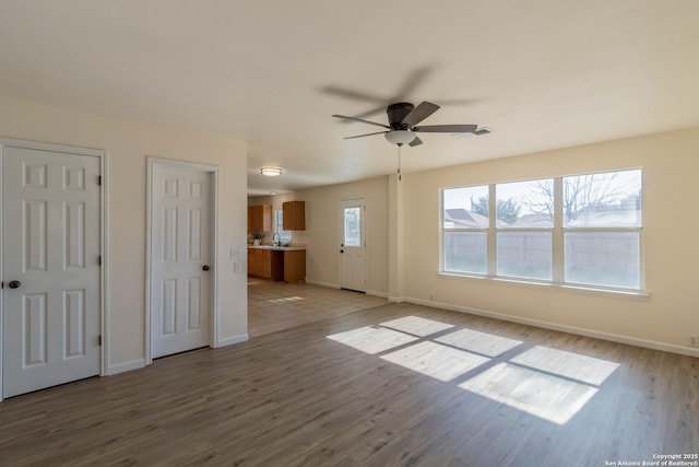 interior space with hardwood / wood-style floors and ceiling fan