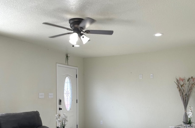 entryway featuring ceiling fan and a textured ceiling