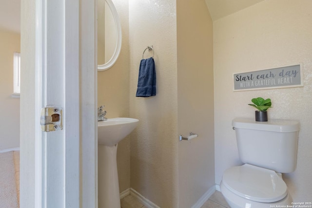 bathroom featuring tile patterned flooring and toilet