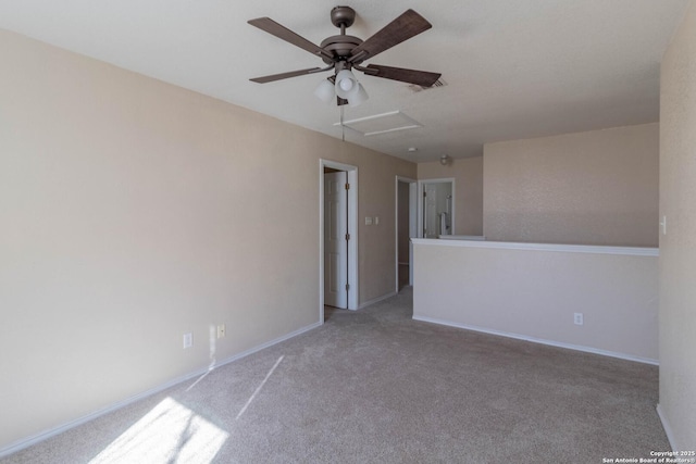 carpeted spare room featuring ceiling fan