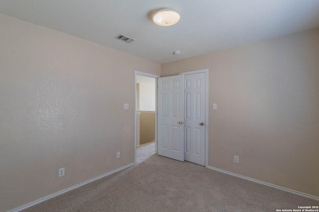 unfurnished bedroom with light carpet