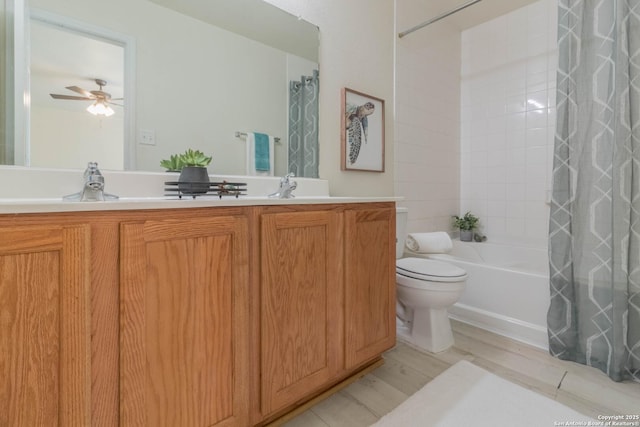 full bathroom with ceiling fan, vanity, wood-type flooring, toilet, and shower / bath combo with shower curtain