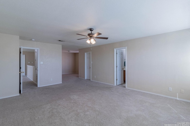 carpeted spare room featuring ceiling fan