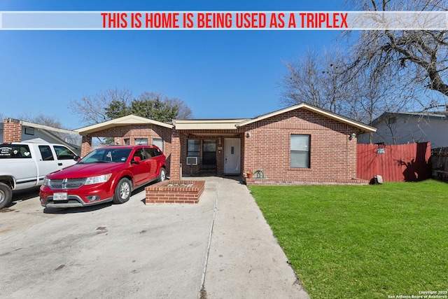 ranch-style house featuring a front yard and a carport