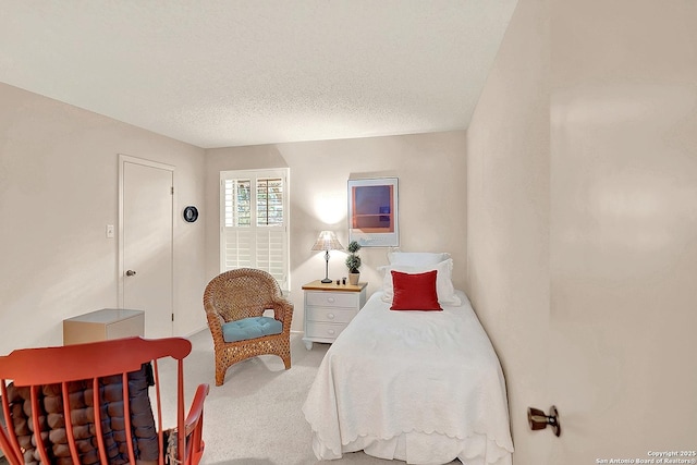 bedroom with carpet and a textured ceiling