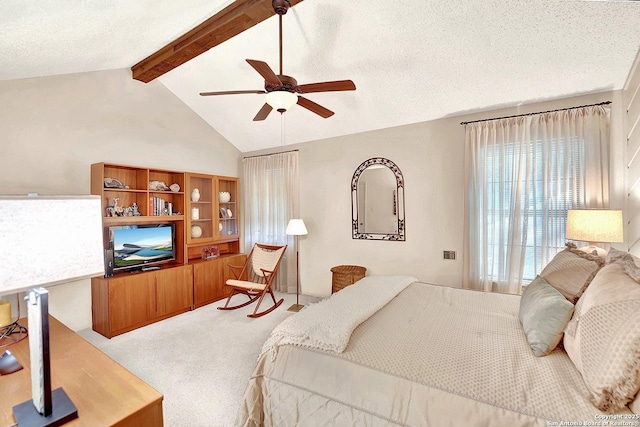 bedroom with ceiling fan, carpet flooring, vaulted ceiling with beams, and a textured ceiling