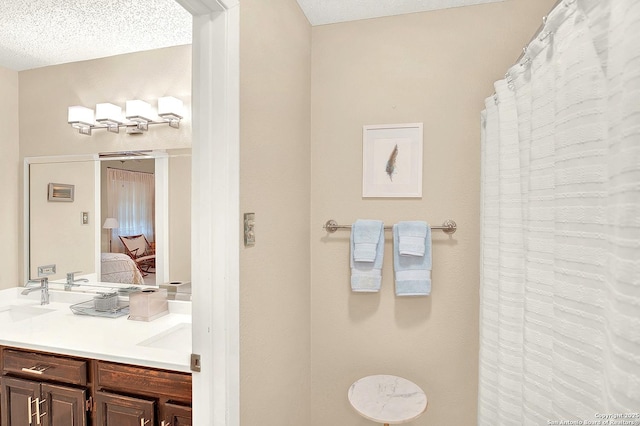 bathroom featuring vanity and a textured ceiling