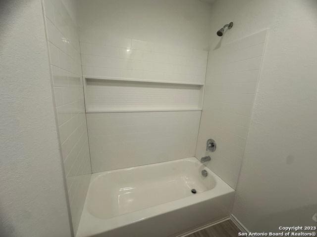 bathroom featuring tiled shower / bath and hardwood / wood-style floors