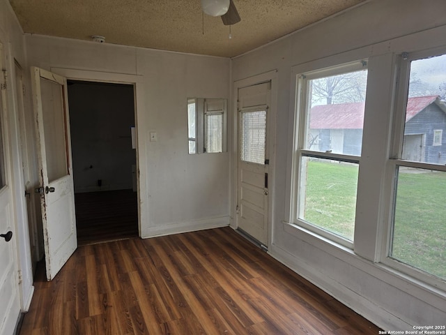 unfurnished room with dark hardwood / wood-style floors and a textured ceiling