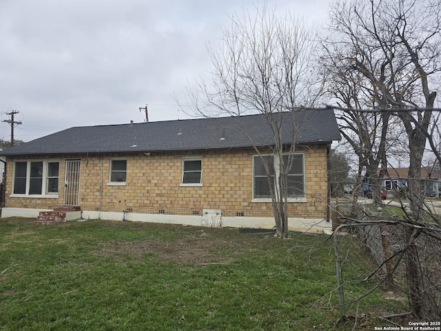 rear view of property with a lawn