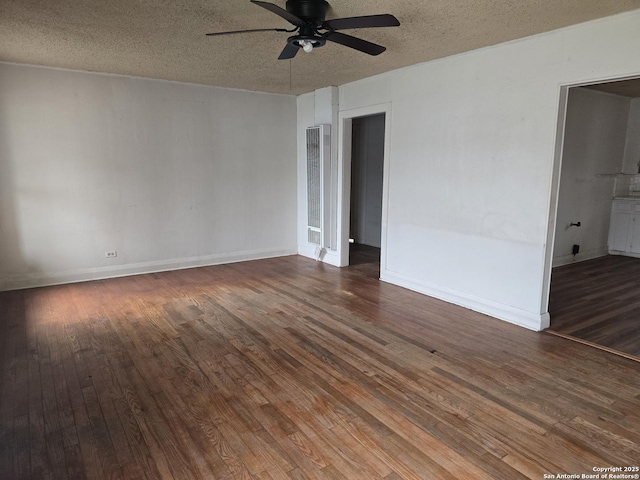 unfurnished room with ceiling fan, dark hardwood / wood-style flooring, and a textured ceiling