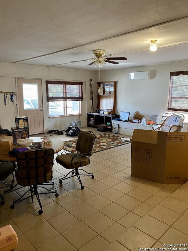 tiled living room featuring ceiling fan and a wall unit AC