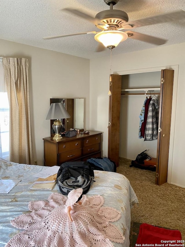 bedroom featuring ceiling fan, a closet, carpet flooring, and a textured ceiling