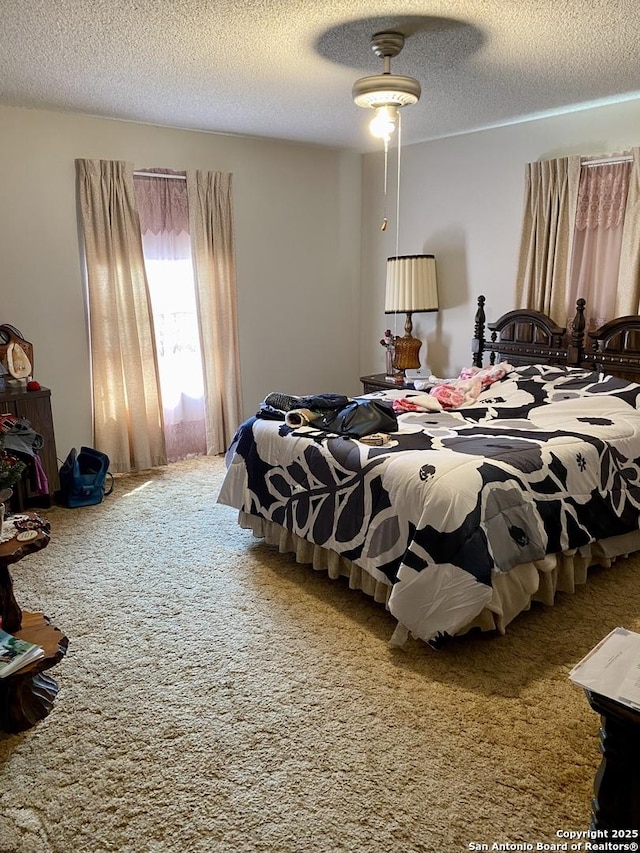 bedroom with a textured ceiling and carpet