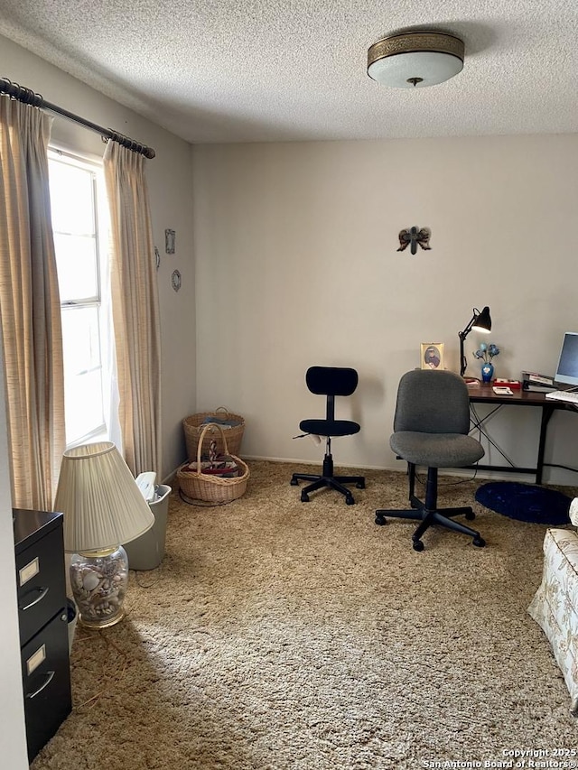 home office featuring carpet and a textured ceiling