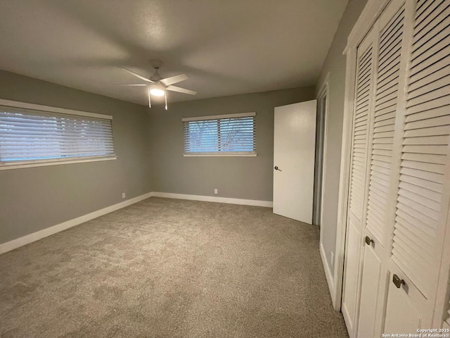 unfurnished bedroom featuring a closet, ceiling fan, and carpet