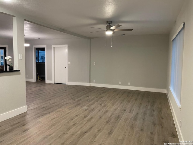 spare room featuring ceiling fan, wood-type flooring, and a textured ceiling