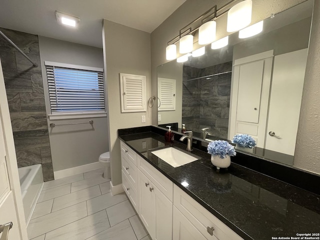 full bathroom with vanity, tiled shower / bath combo, and toilet