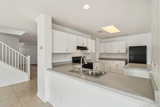 kitchen featuring sink, light tile patterned floors, black appliances, white cabinets, and kitchen peninsula