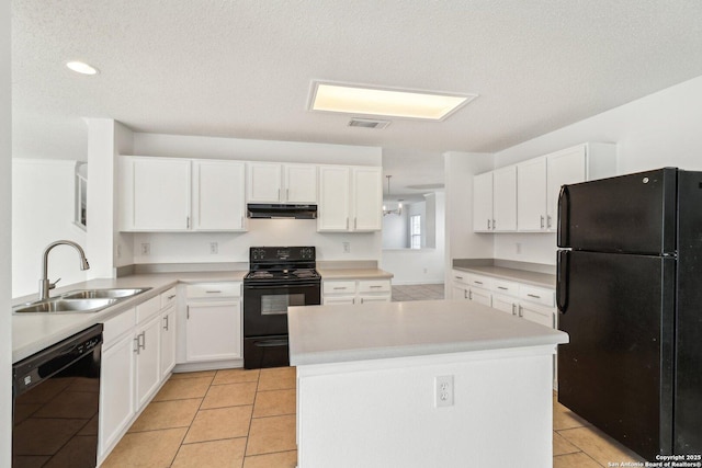 kitchen with sink, white cabinetry, black appliances, a kitchen island, and light tile patterned flooring