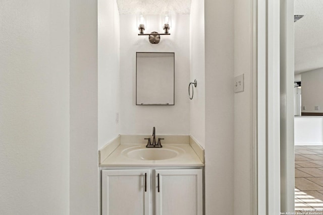 bathroom featuring vanity and a textured ceiling