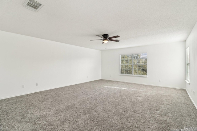 carpeted spare room featuring ceiling fan and a textured ceiling