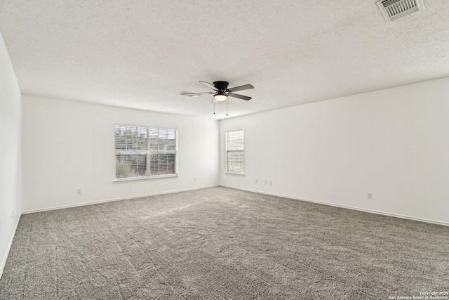 empty room featuring ceiling fan, carpet floors, and a textured ceiling