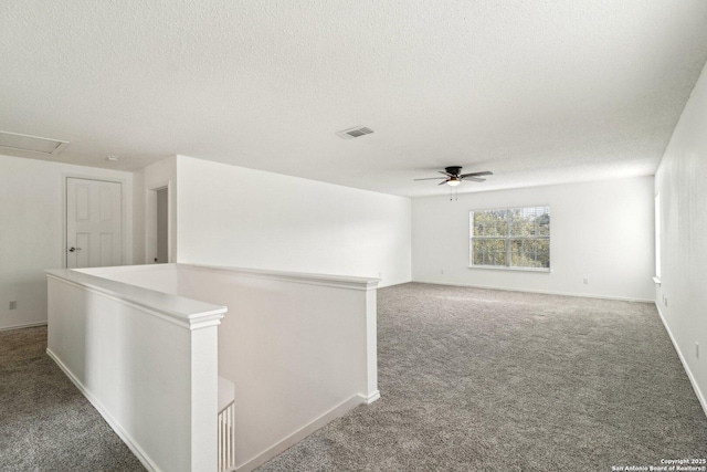 spare room with ceiling fan, carpet floors, and a textured ceiling