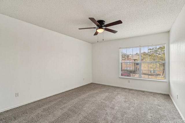 carpeted empty room with ceiling fan and a textured ceiling