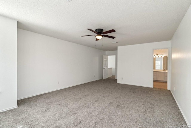 unfurnished bedroom with connected bathroom, carpet floors, a textured ceiling, and ceiling fan