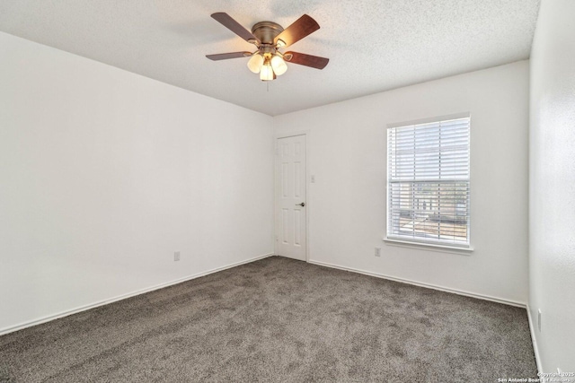 carpeted empty room featuring ceiling fan and a textured ceiling