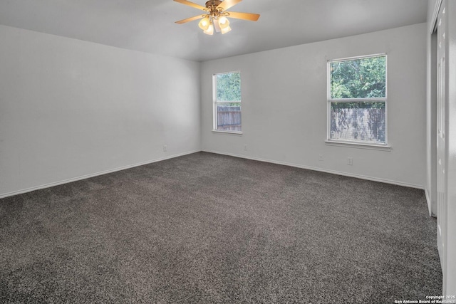 carpeted empty room featuring ceiling fan